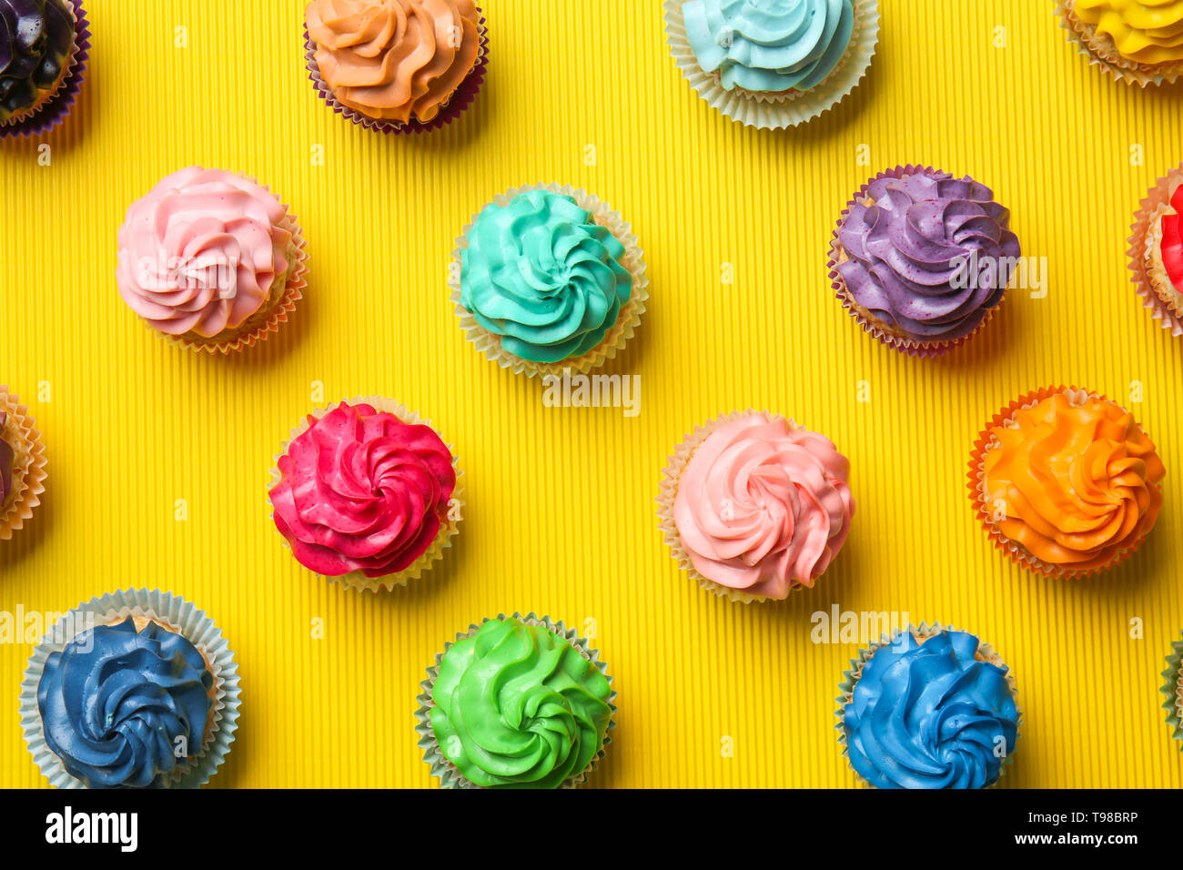 Different cupcakes on color background Stock Photo
