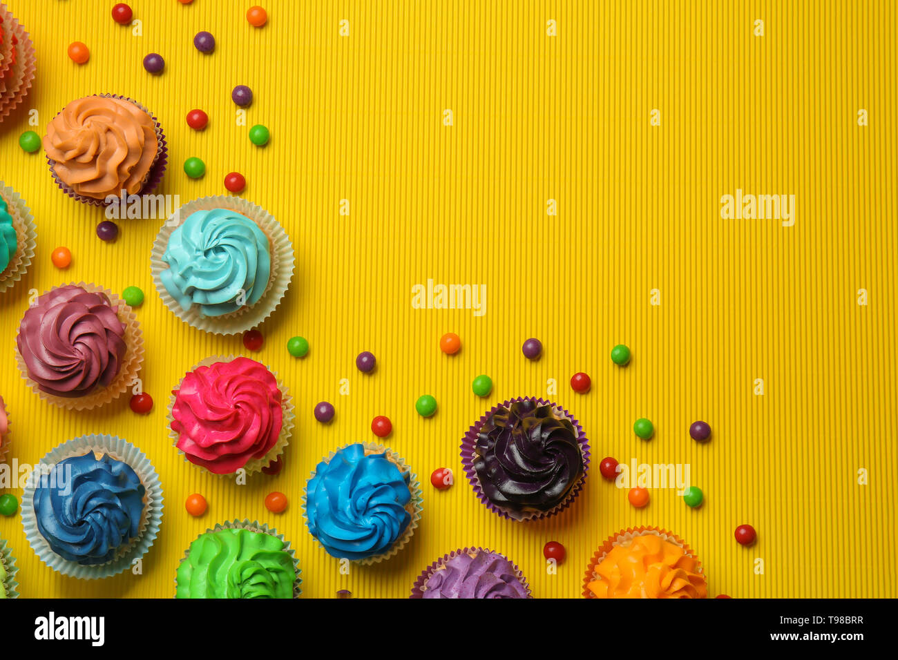 Different cupcakes on color background Stock Photo