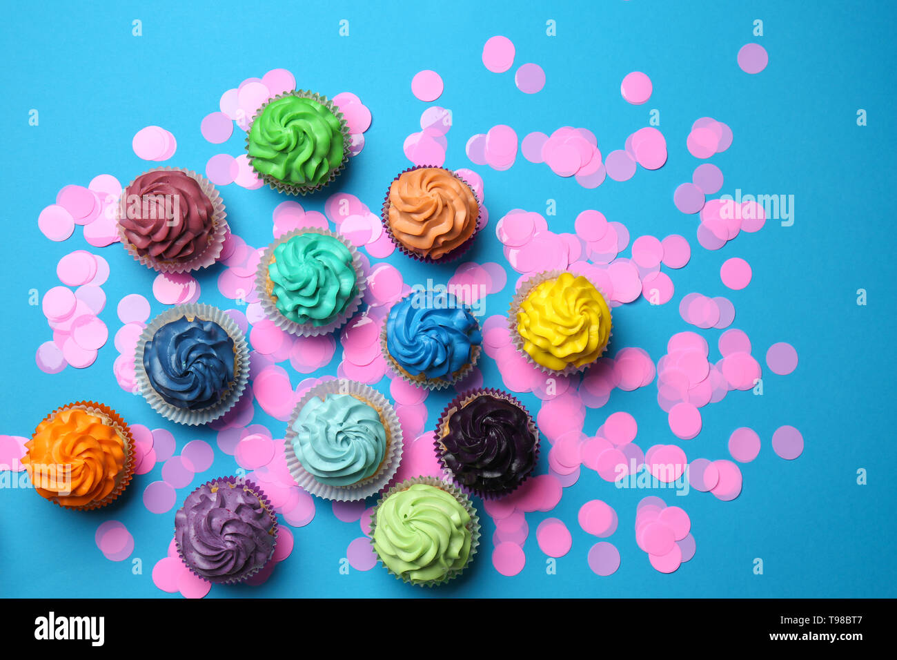 Different cupcakes on color background Stock Photo
