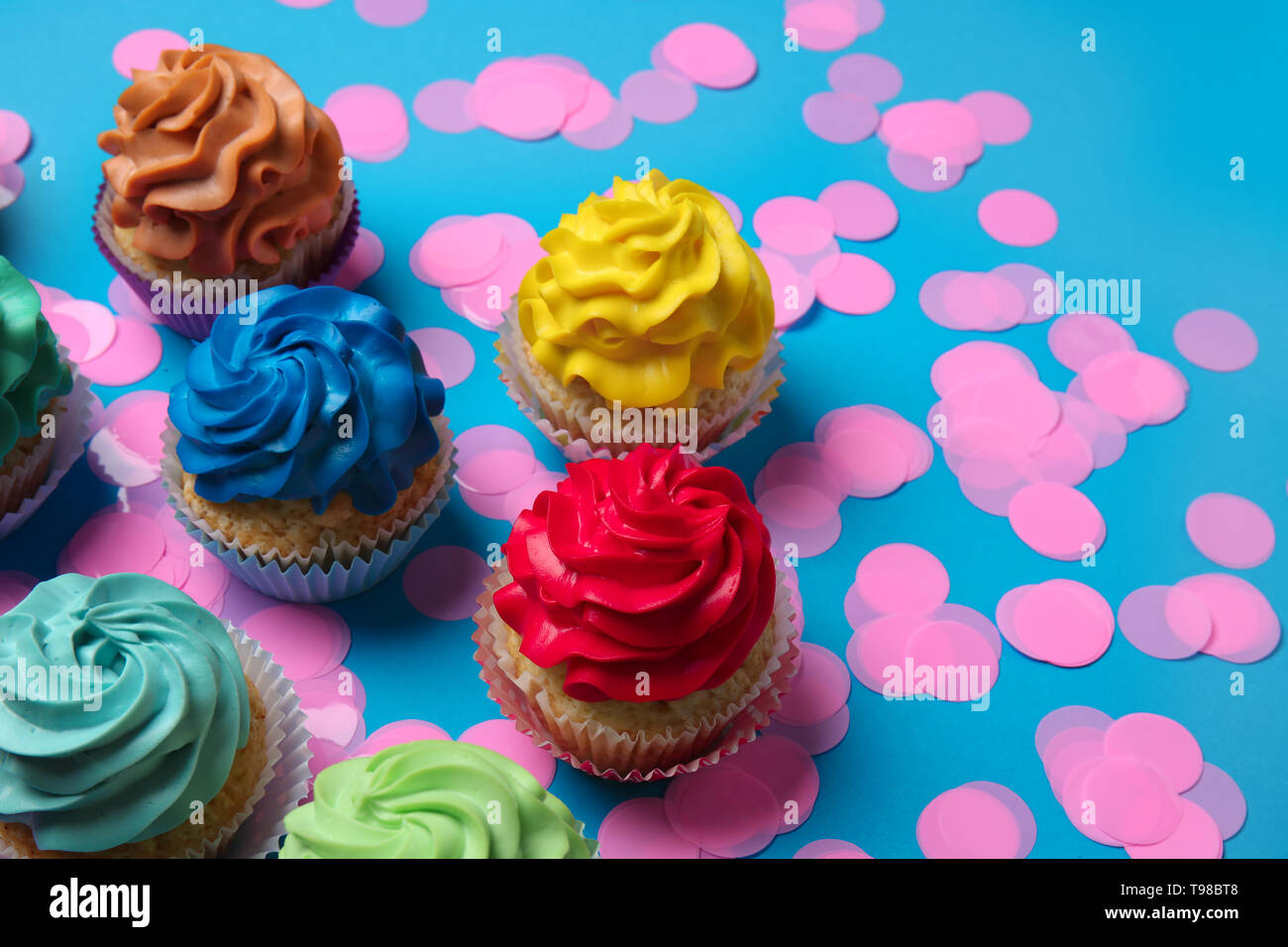 Different cupcakes on color background Stock Photo