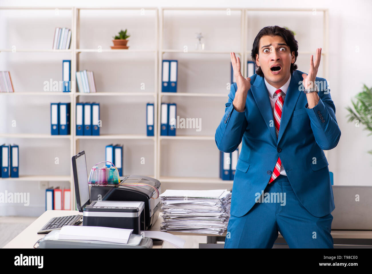 Young employee making copies at copying machine Stock Photo - Alamy