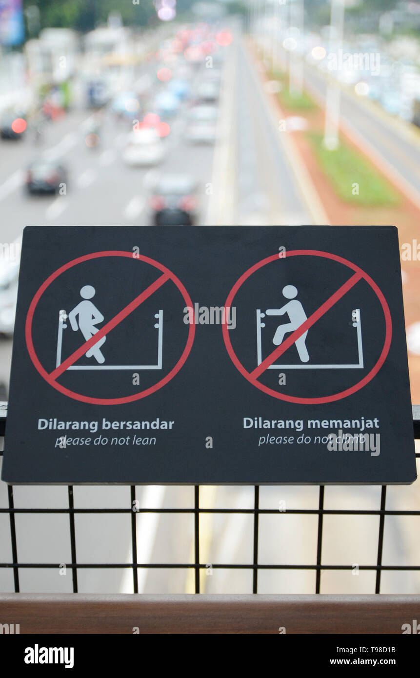 signage in the crossing bridge at Sudirman Street, Jakarta, to make people more careful and fill safe Stock Photo