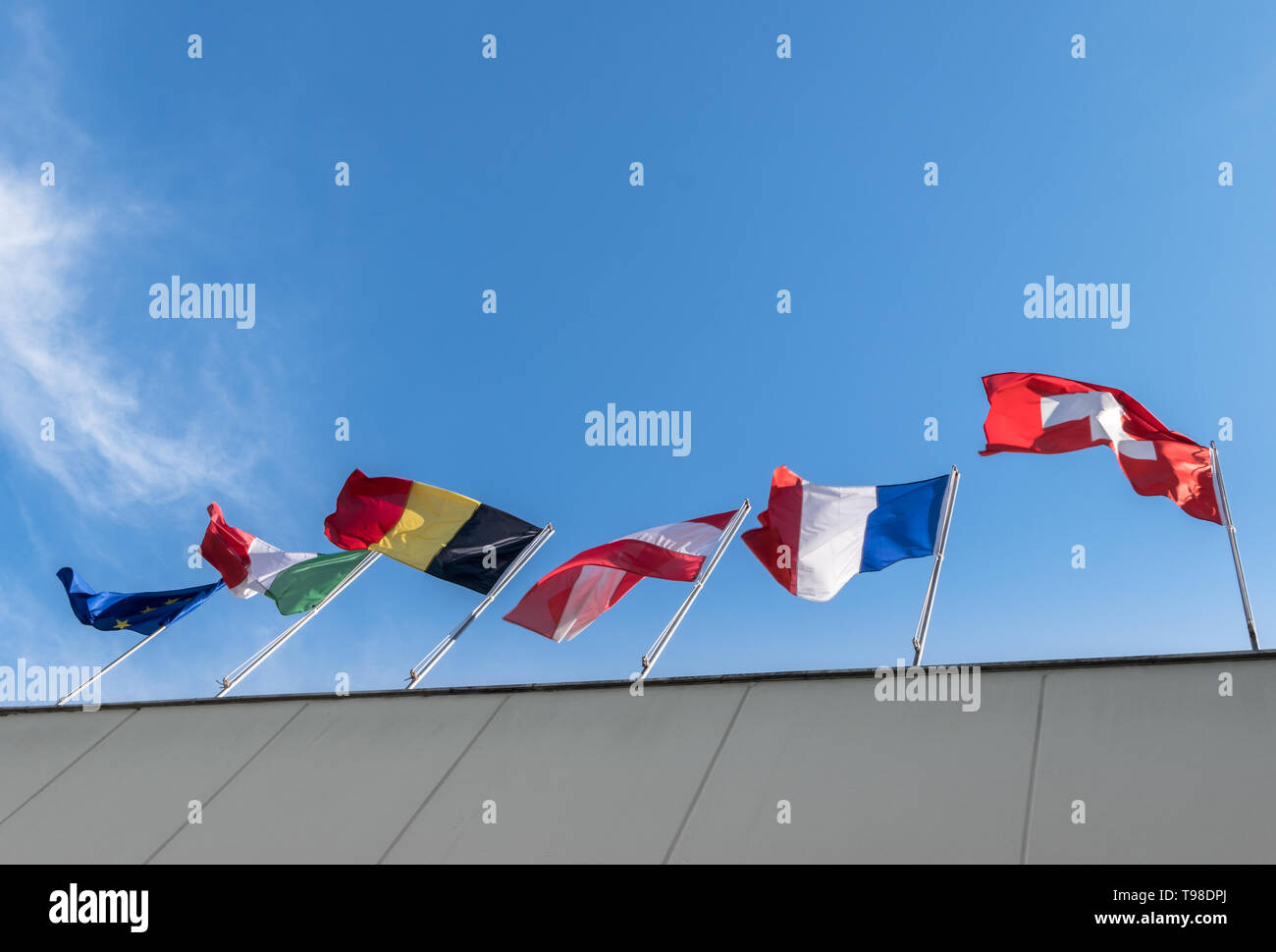 European Union Flags against a blue sky background. Bottom view. Stock Photo