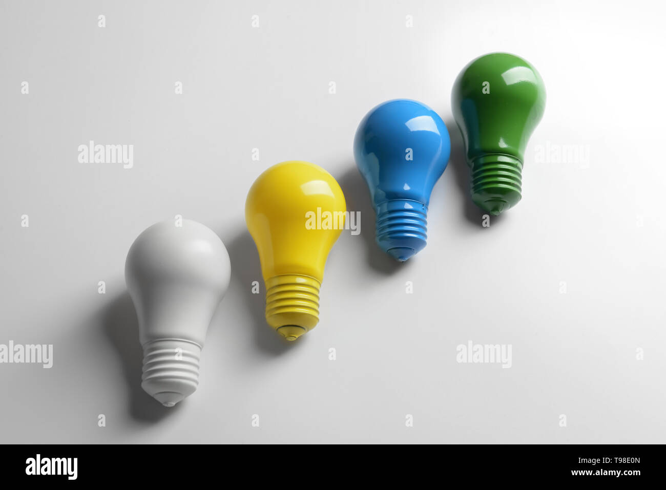 Painted light bulbs on white background Stock Photo