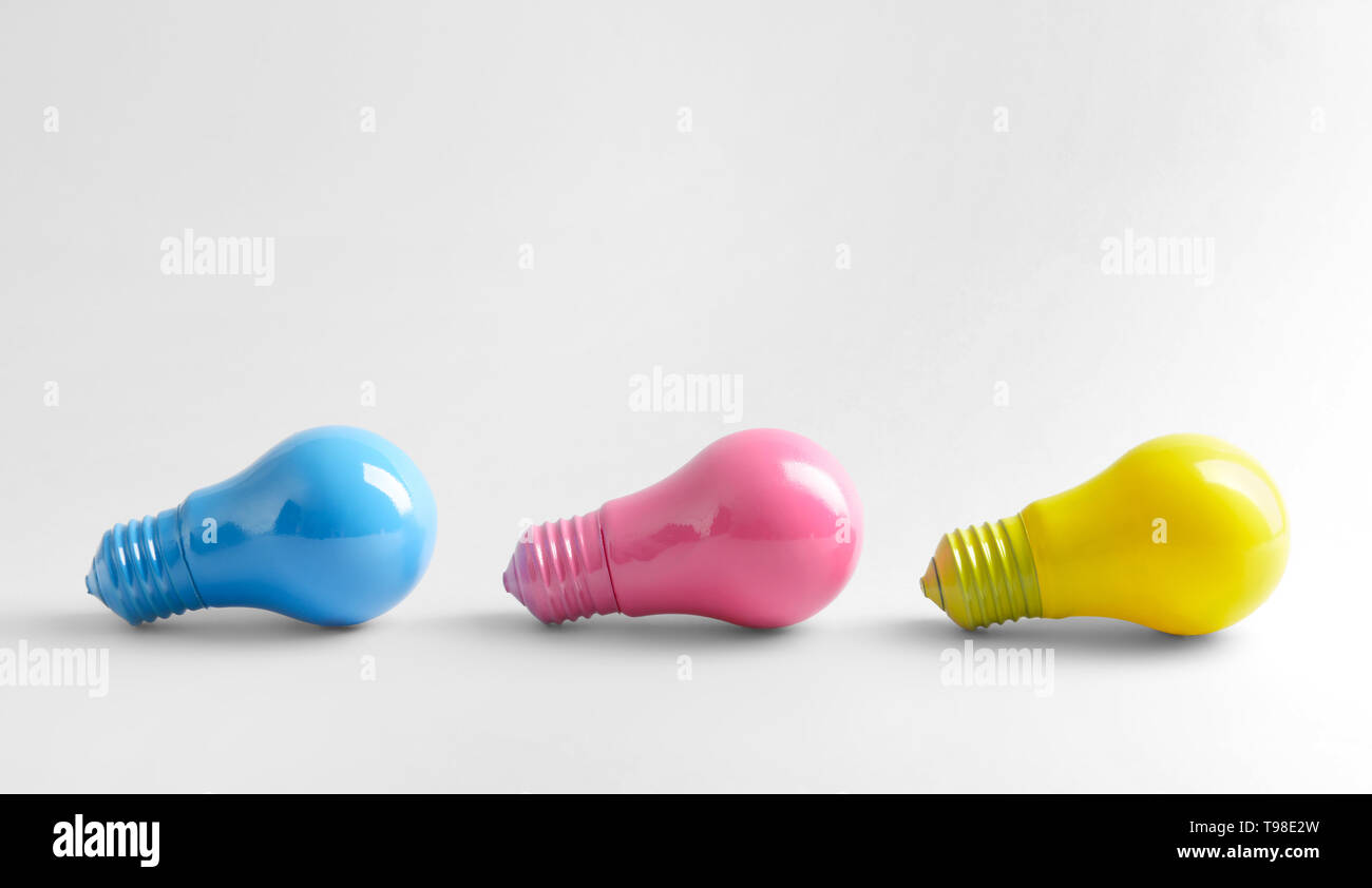 Painted light bulbs on white background Stock Photo