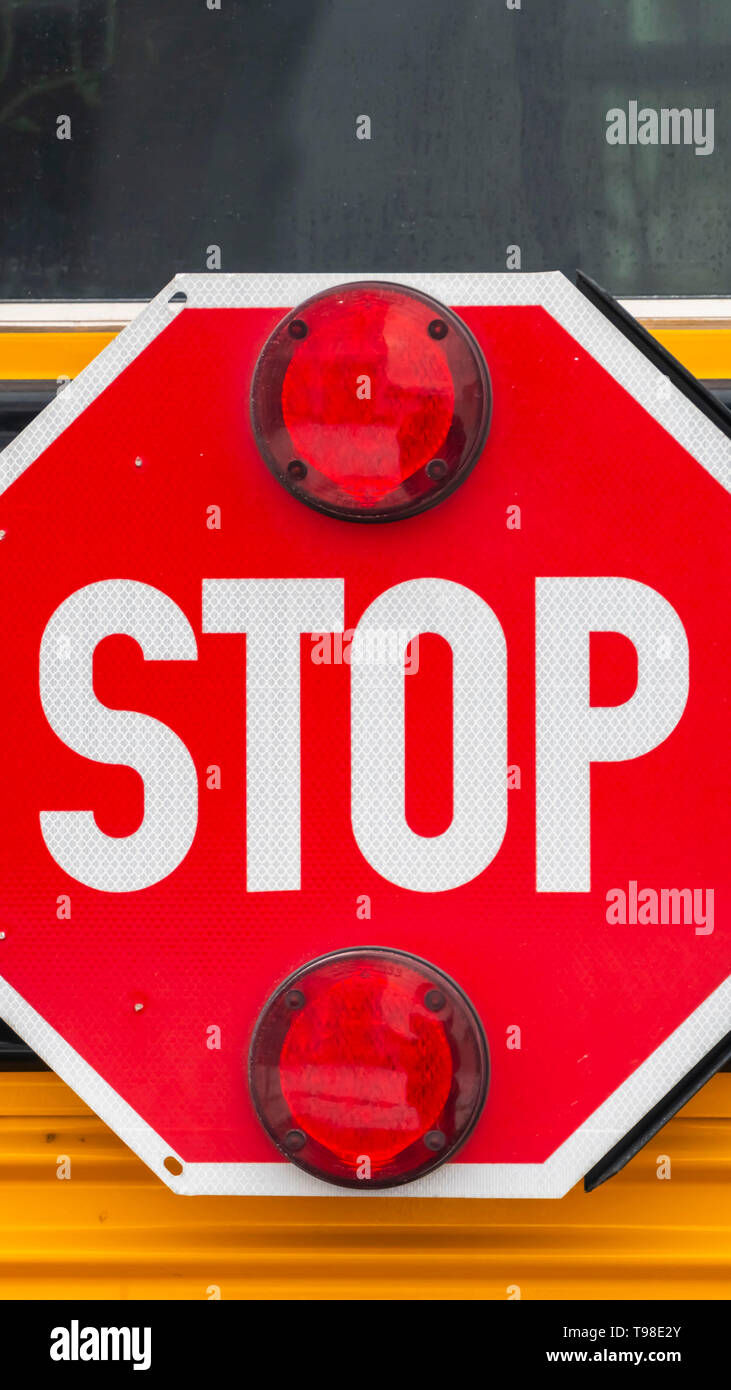 Clear Vertical Close up of an octagon shaped red stop sign with signal
