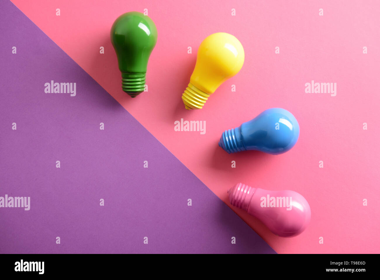 Painted light bulbs on color background Stock Photo