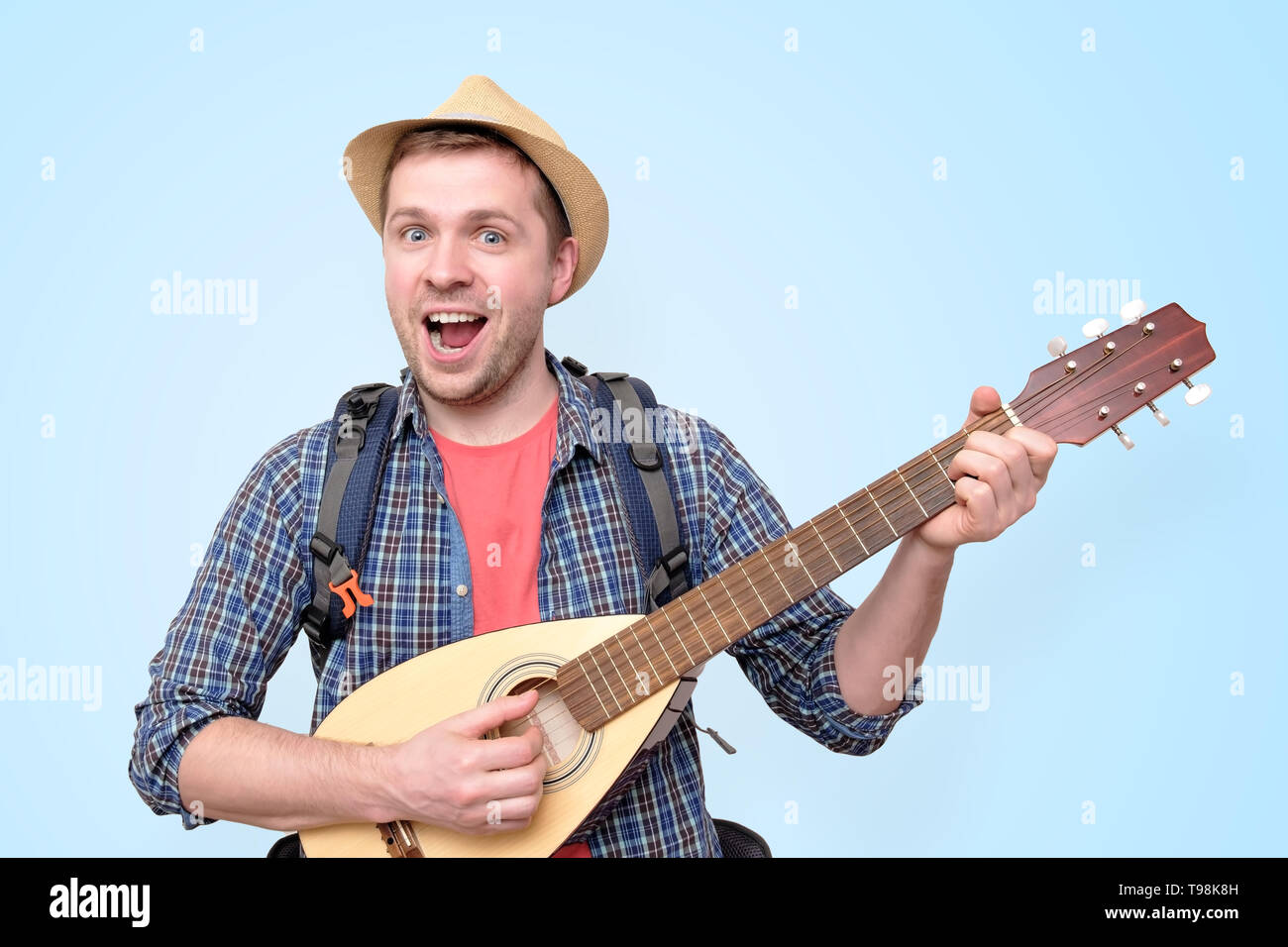 Young tourist man playing guitar and singing Stock Photo