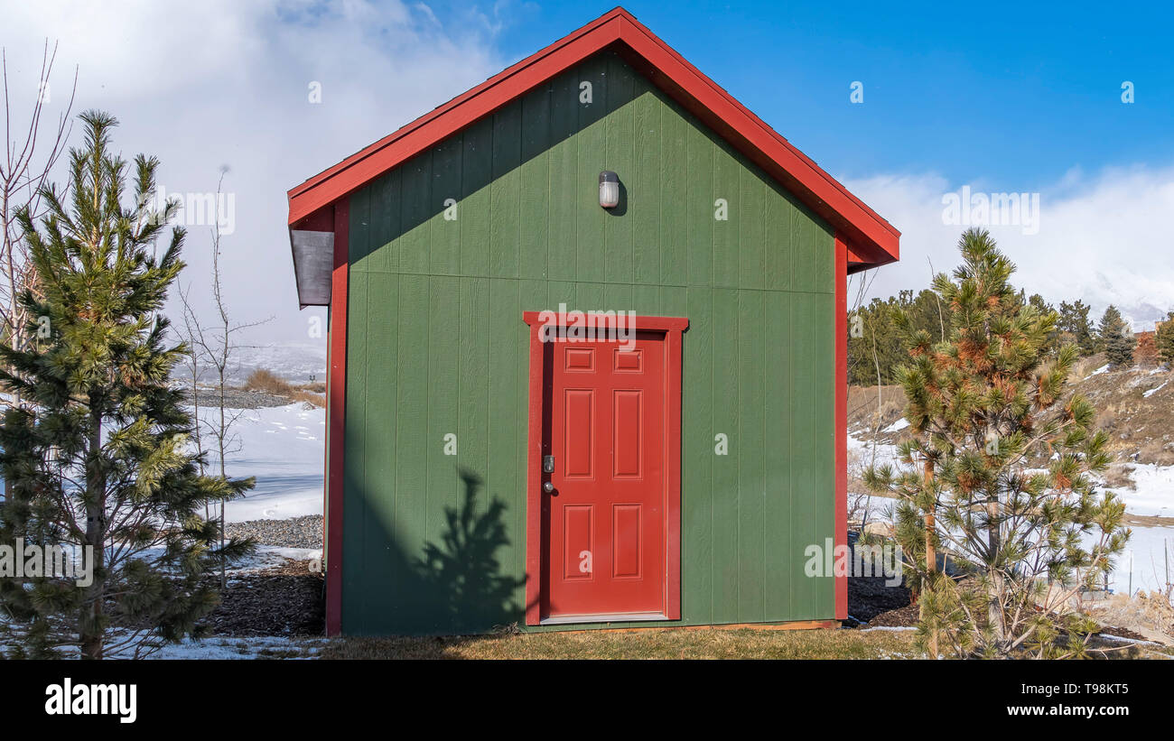 Panorama Small Wooden Storage Shed With A Lamp On The Green