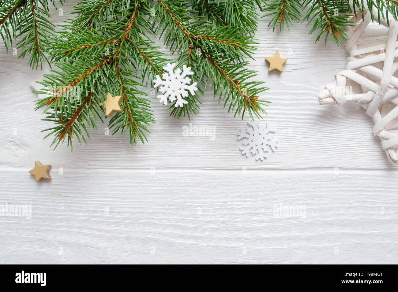 Christmas fir tree branch on white wooden background. Pine branch. Place for text. Elements for decoration of x-mas decor branch of green spruce Stock Photo