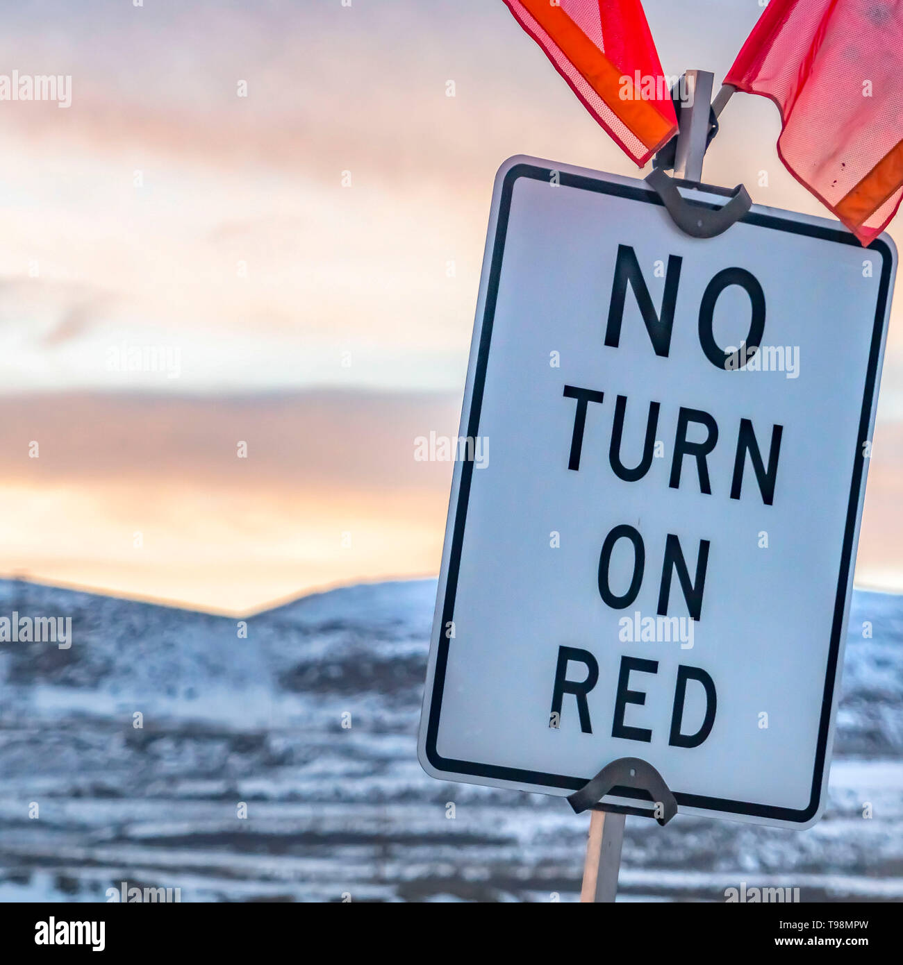 Clear Square Close up of a No Turn On Red sign with red flags on top