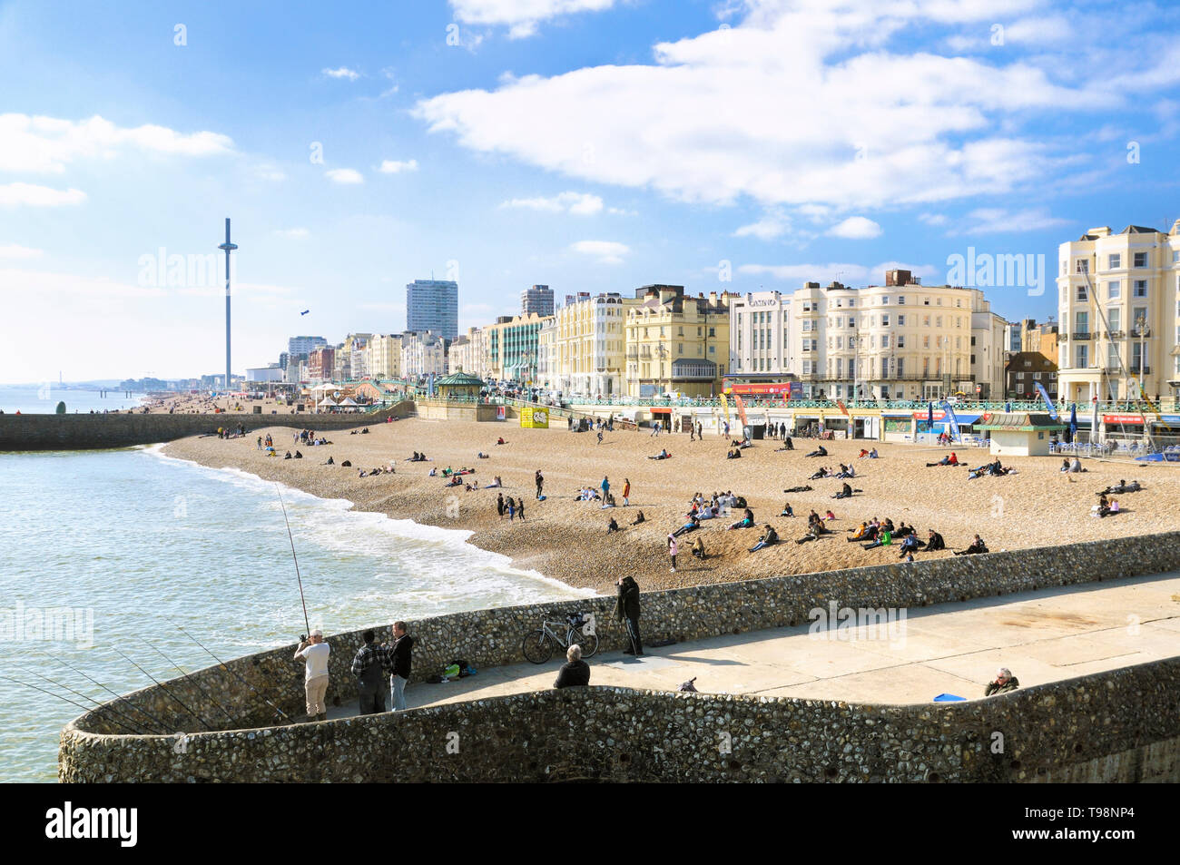 A view of Brighton beach and seafront hotels on the promenade as seen from Palace Pier, Brighton and Hove, East Sussex, England, UK Stock Photo