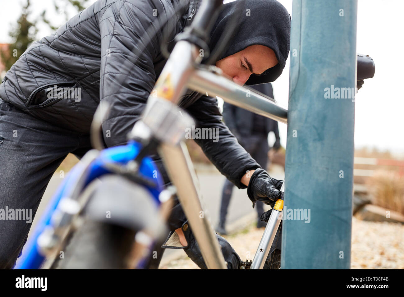 Bicycle theft in the city with thief and bike Stock Photo