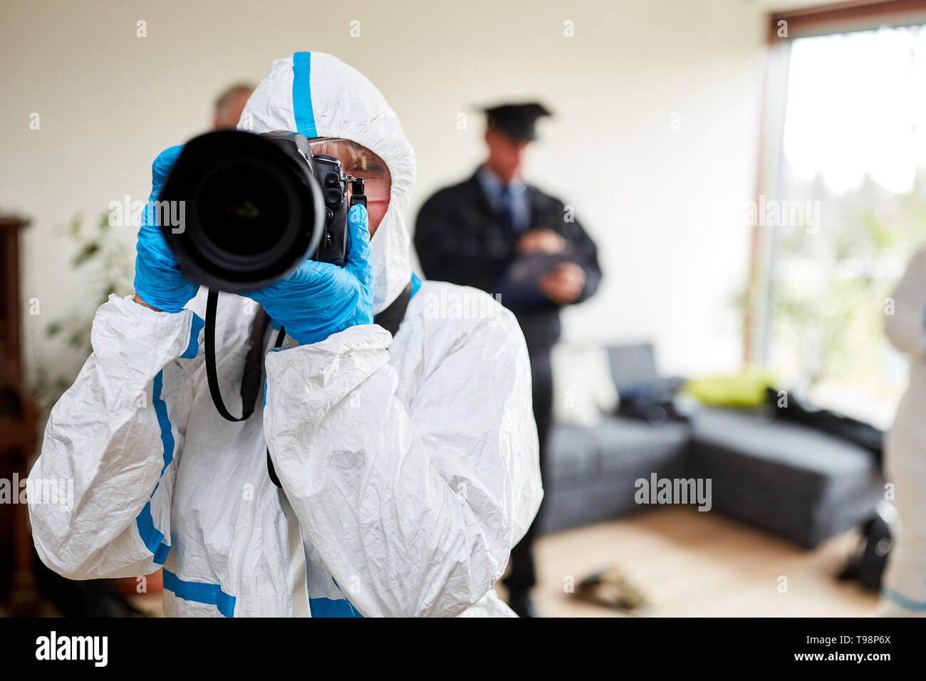Photographer of the police at the scene after a burglary in the crime scene Stock Photo