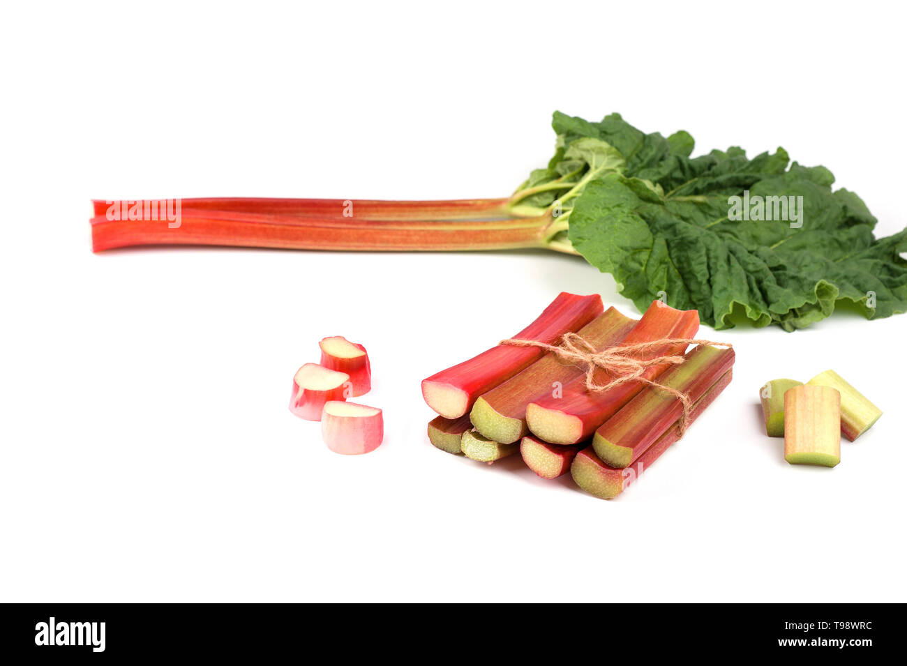 Rhubarb isolated. Red stalks, bunch of cut rhubarb  on white background.Fresh and juicy ready to be cooked.Image with  selective focus and copy space. Stock Photo