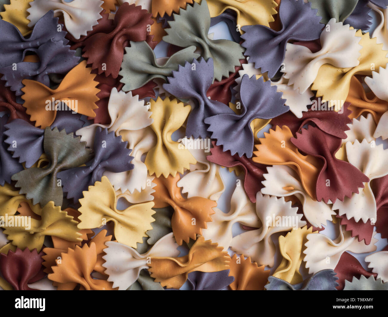 colorful Italian pasta background. Various colors of bow tie farfalle