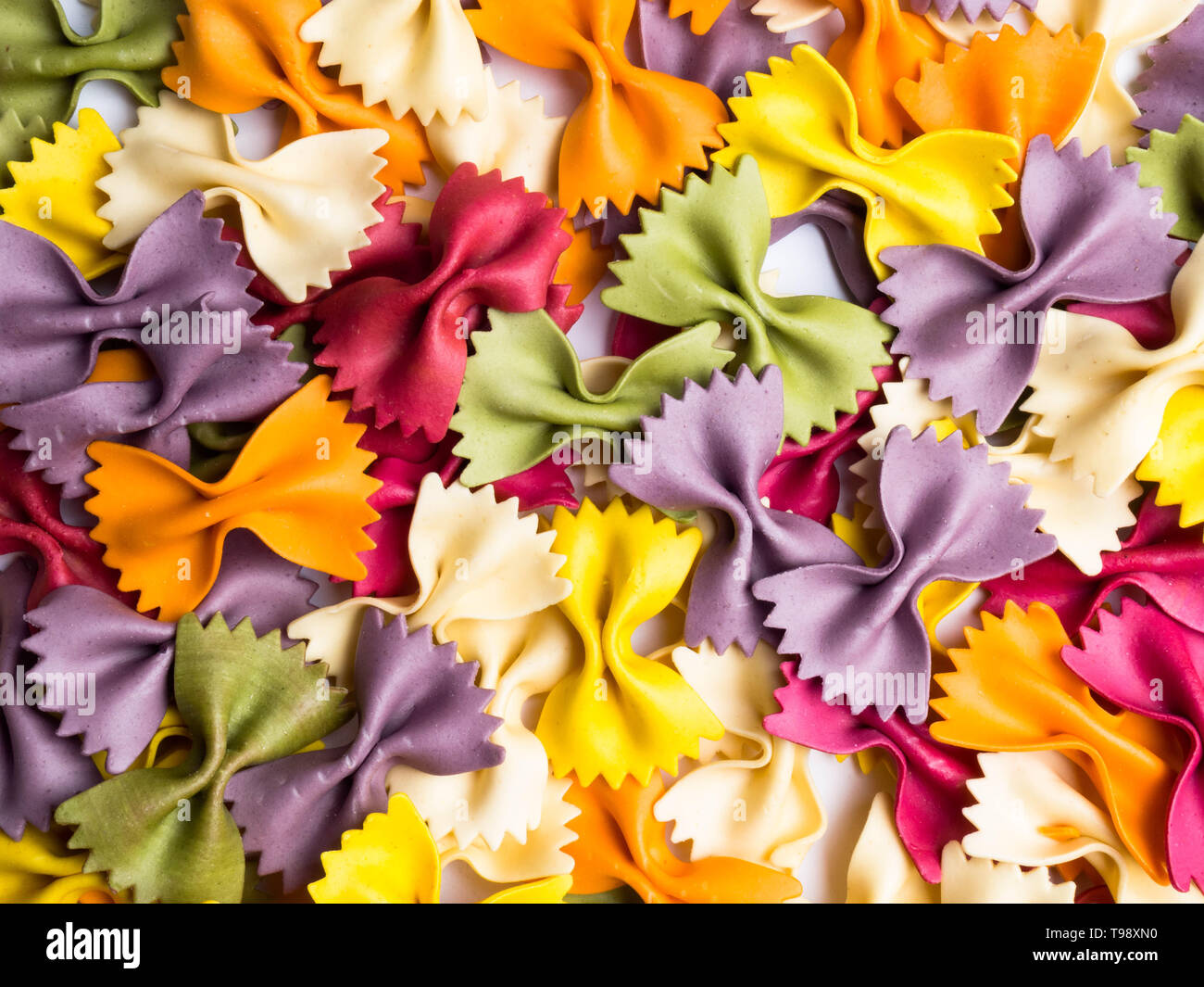 colorful Italian pasta background. Various colors of bow tie farfalle