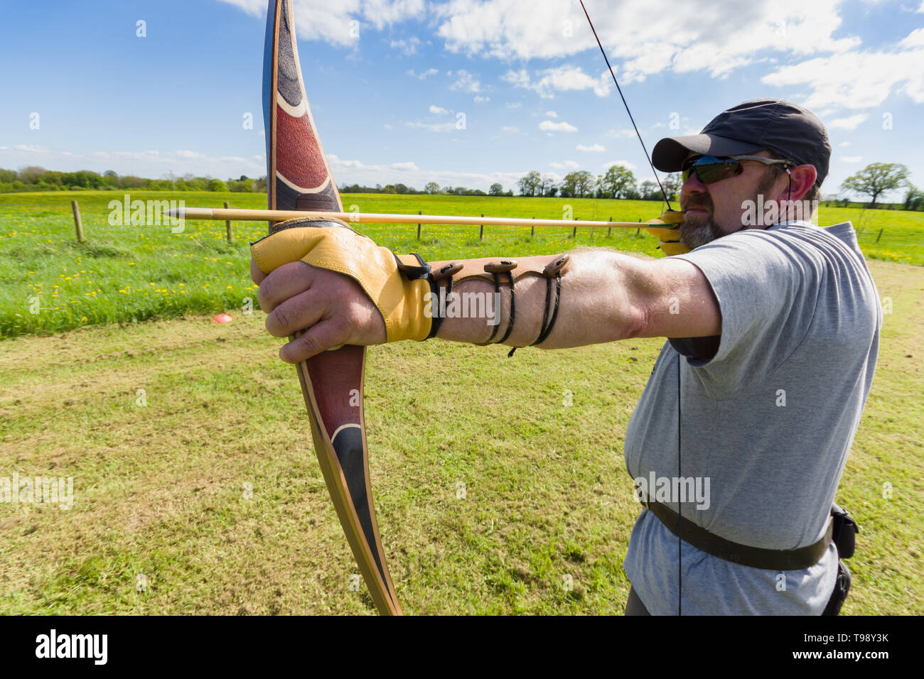 A field archer preparing to loose an arrow using an American laminated