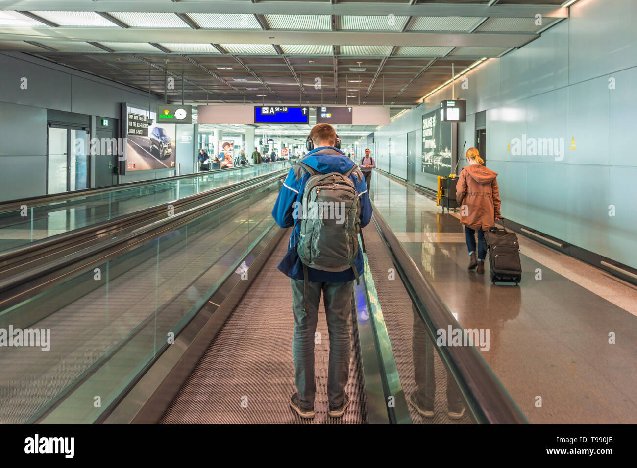 Moving walkway with a man at an airport Stock Photo