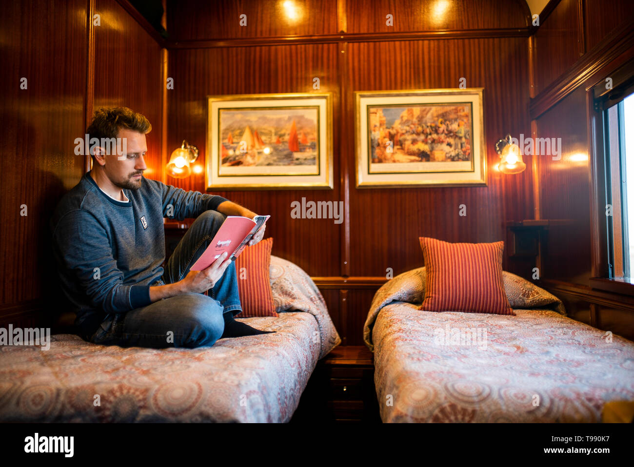 Man in sleeping compartment of African Explorer, special train, Namibia, Africa Stock Photo