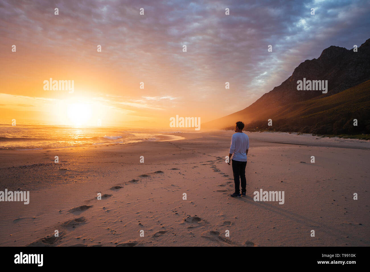 Man on the beach at sunset, Western Cape, South Africa Stock Photo