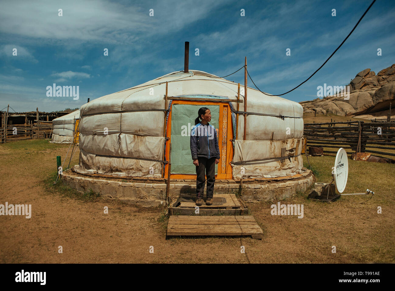 Nomad woman stands in front of yurt, Mongolian Switzerland, Gobi Desert, Mongolia Stock Photo