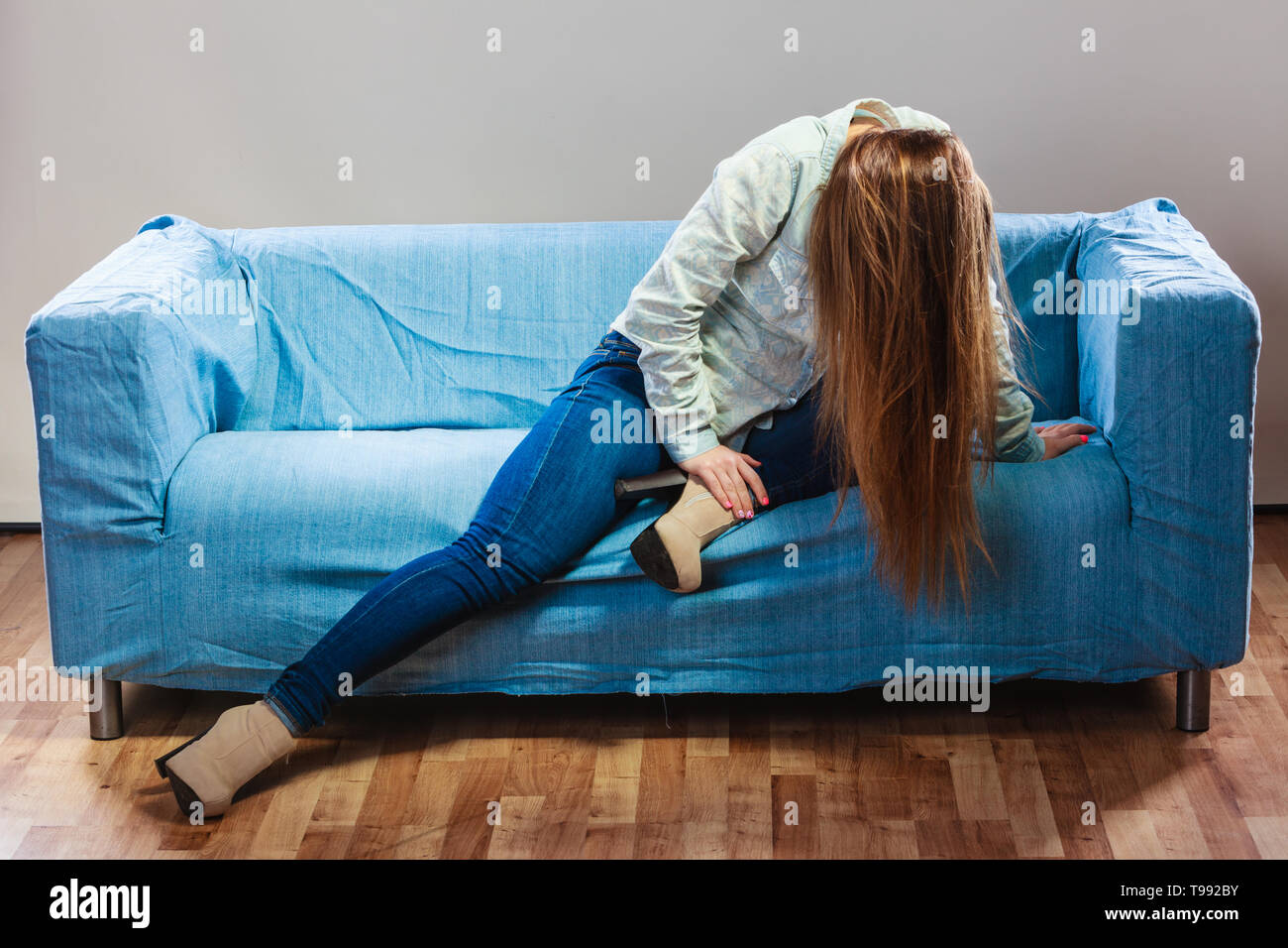 Sad depressed woman on sofa at home. Breakdown and negative emotion