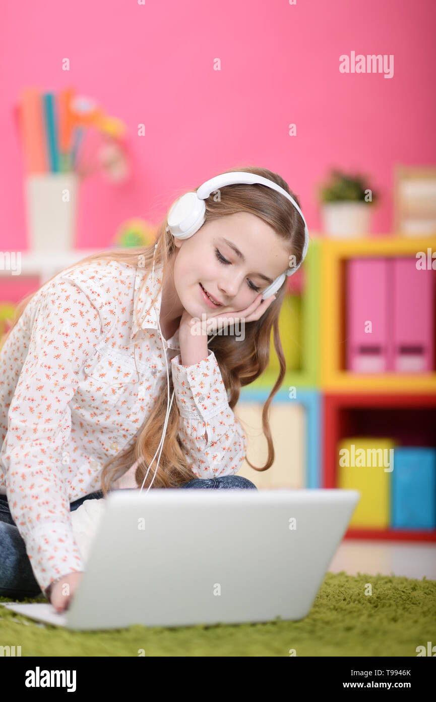 Portrait of cute girl using laptop in floor Stock Photo - Alamy