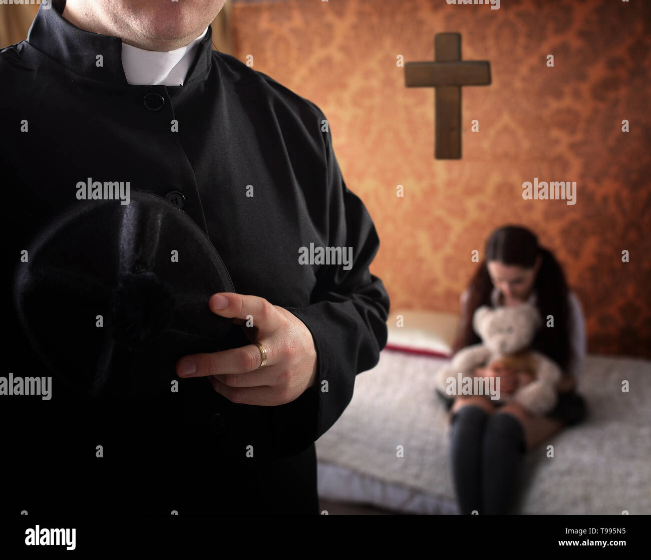 priest and young crying girl Stock Photo
