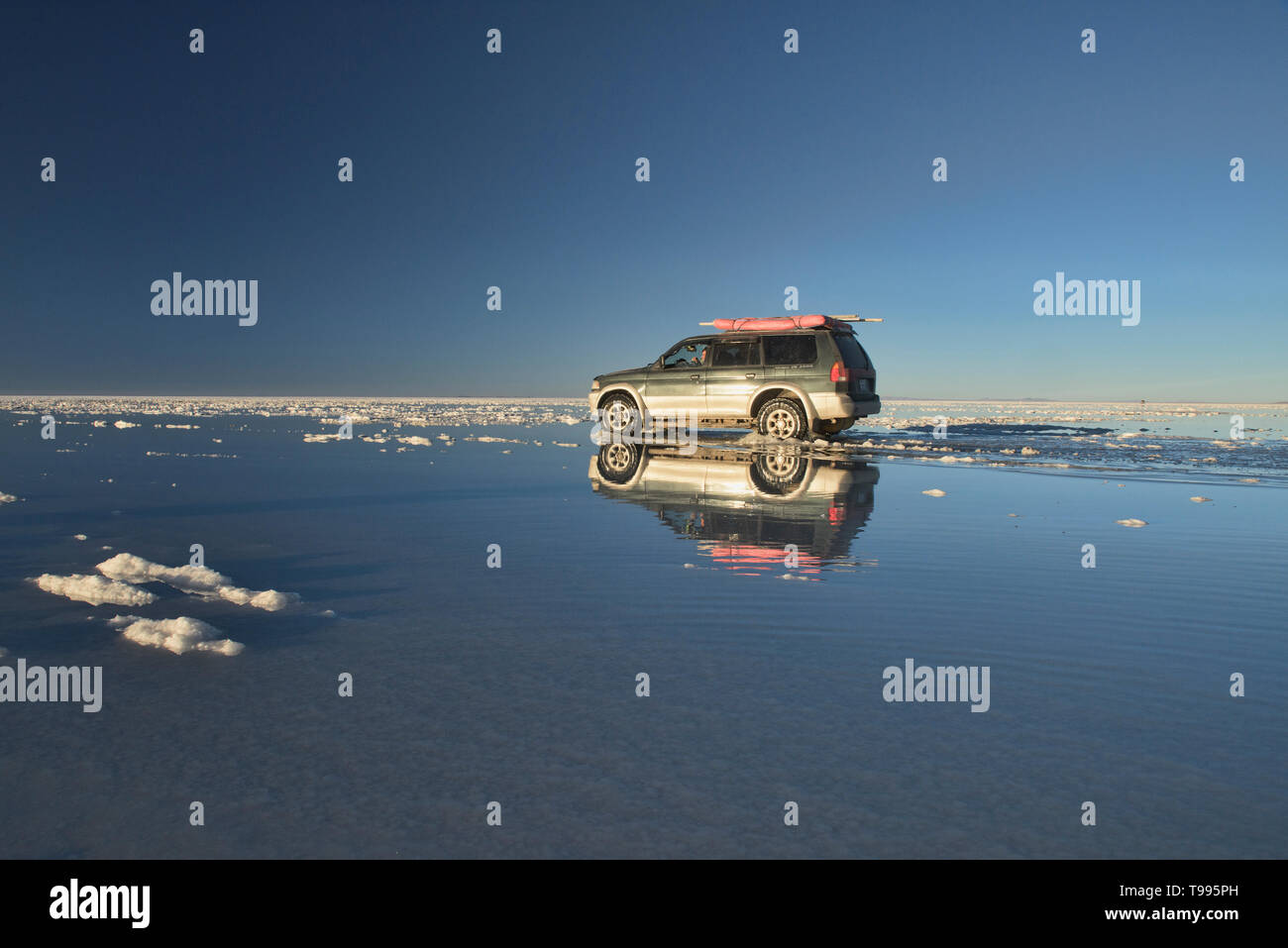 Touring on the world's largest mirror, reflections from the salt flats of the Salar de Uyuni, Bolivia Stock Photo