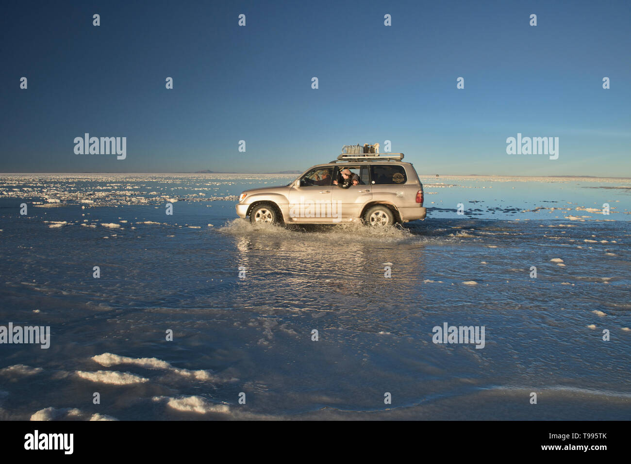 Touring on the world's largest mirror, reflections from the salt flats of the Salar de Uyuni, Bolivia Stock Photo