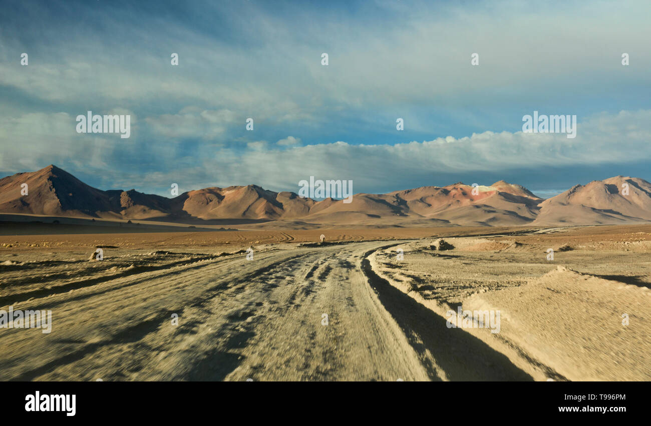 Driving into a rainbow valley, Salar de Uyuni, Bolivia Stock Photo