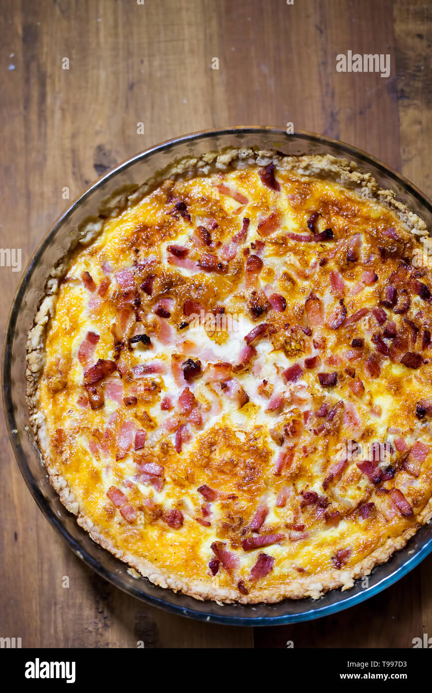 Quiche lorraine on brown table Stock Photo Alamy