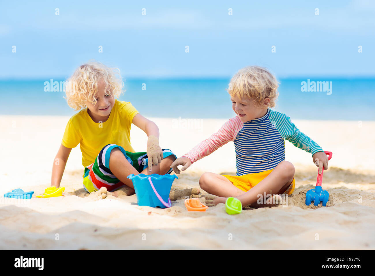 Kids playing on tropical beach. Children play at sea on summer family
