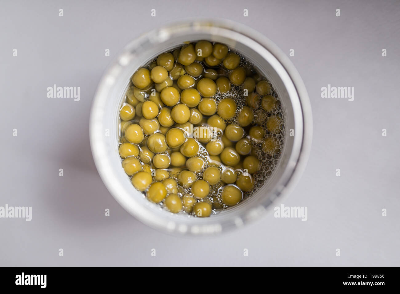 Green peas in can. Top view. Selective focus Stock Photo Alamy