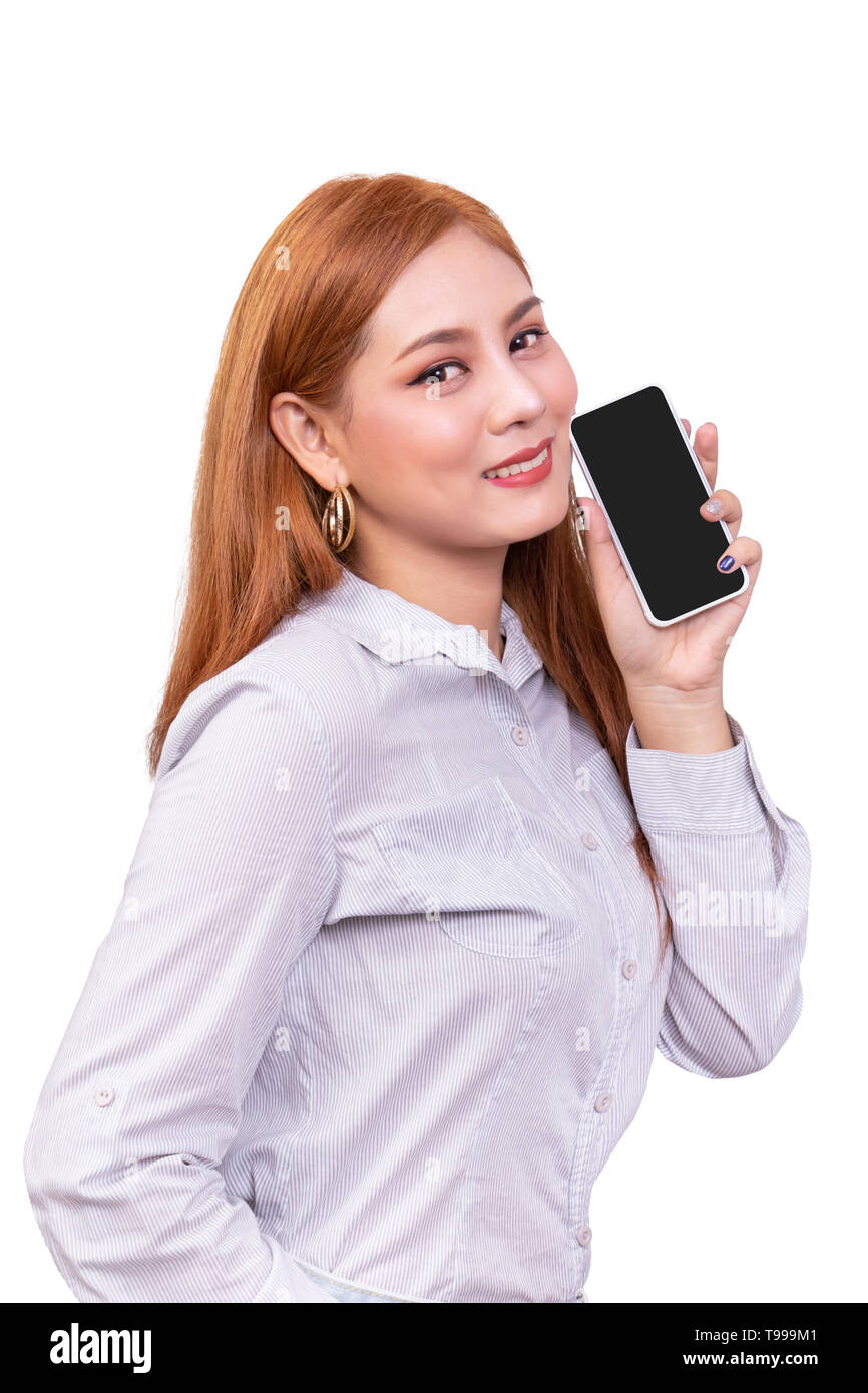 smiling Asian woman holding mobile smartphone with blank black screen standing on white background , clipping path include Stock Photo