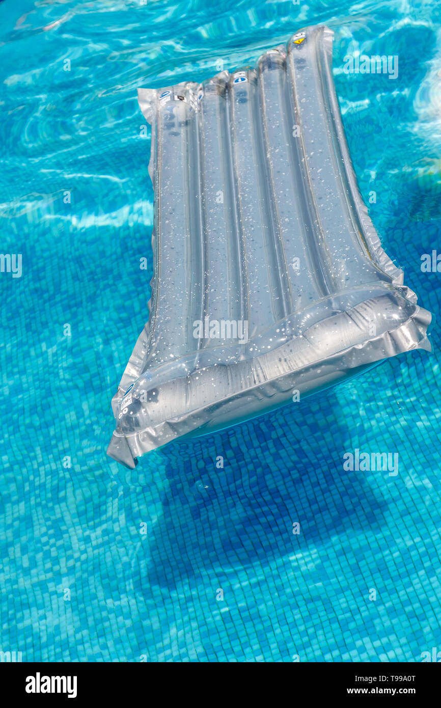 Inflatable water activities mattresses float on the water in the pool