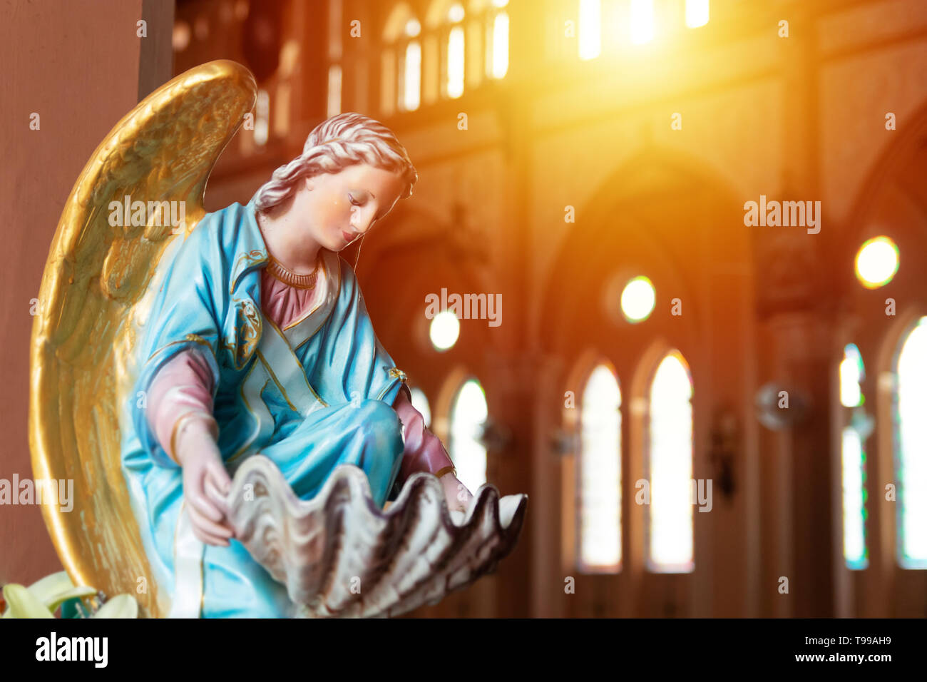 the Virgin Mary statue in church with sun light from top window, christian religion Stock Photo
