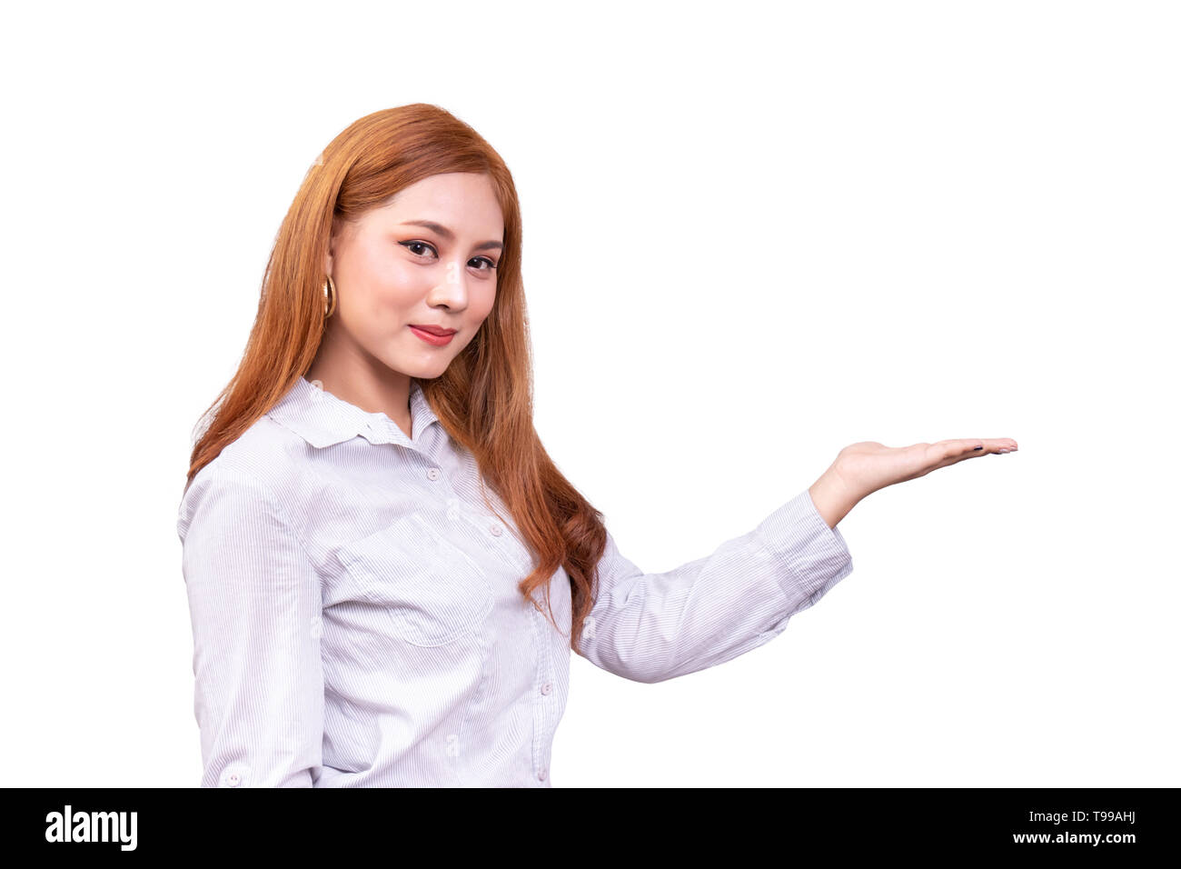 cheerful Asian woman presenting an empty copy space on the open hand palm isolated on white background with clipping path, advertising presentation fo Stock Photo