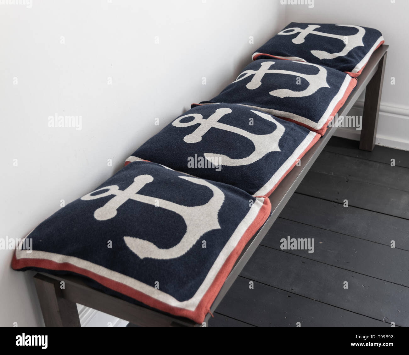 A Wooden Church Pew Bench Covered In A Row Of Anchor Cushions