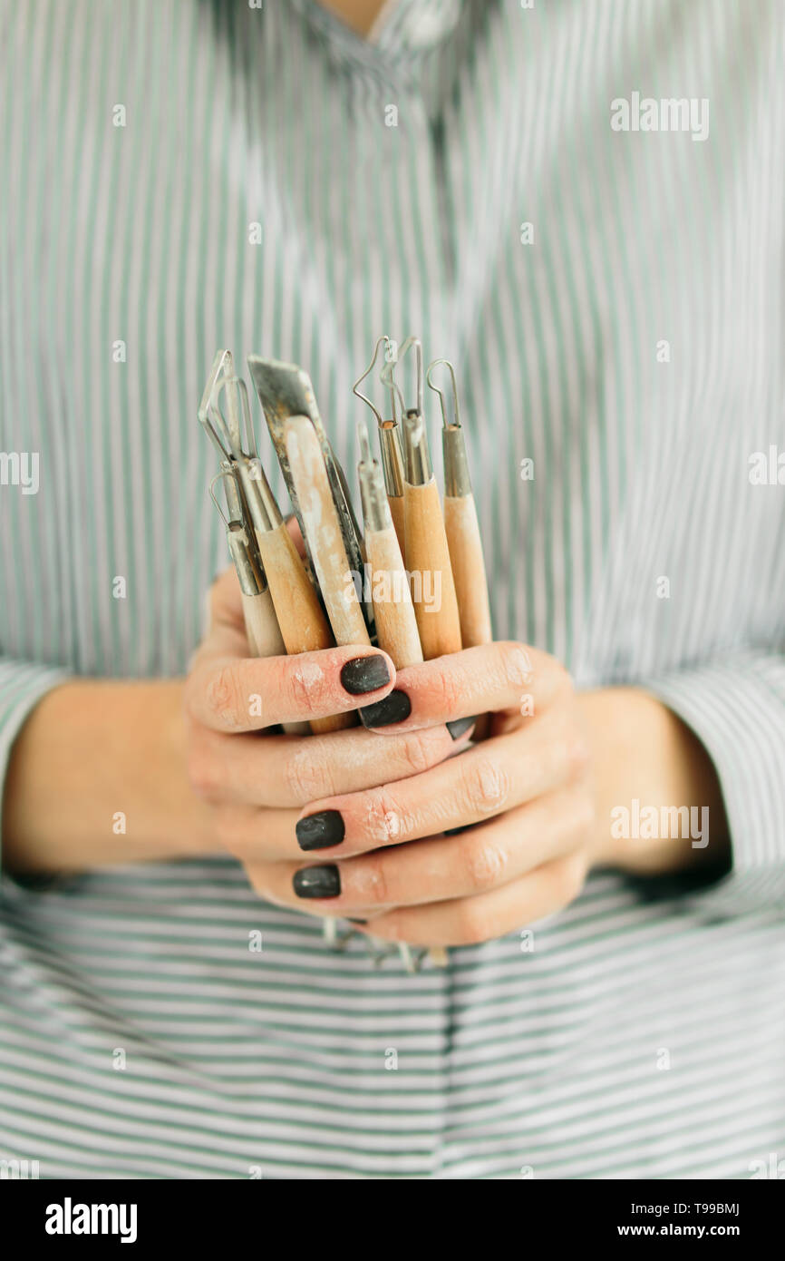 pottery tools for carving ceramic products in workshop Stock Photo