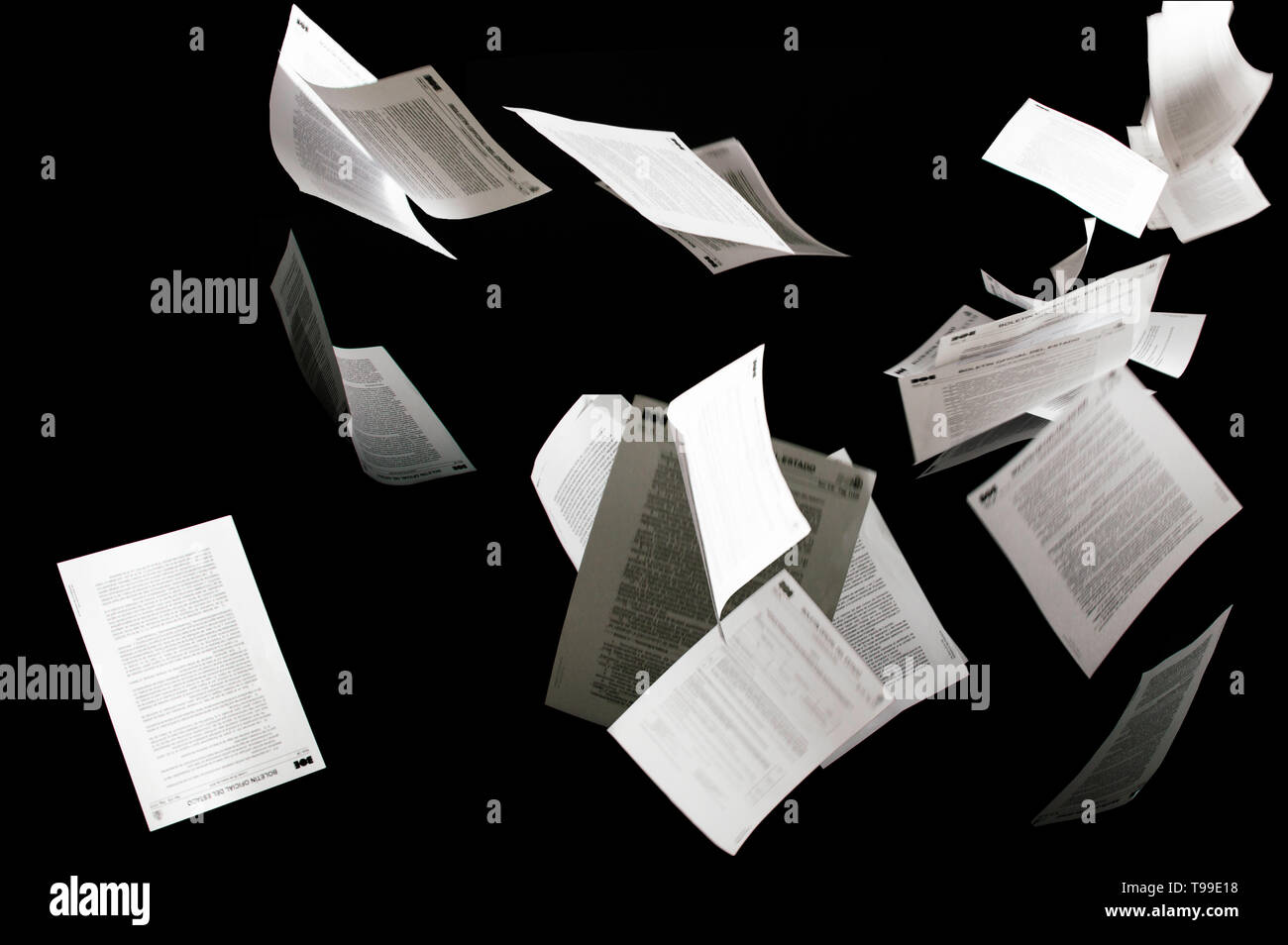Many flying business documents isolated on black background. Papers flying in air in business concept Stock Photo