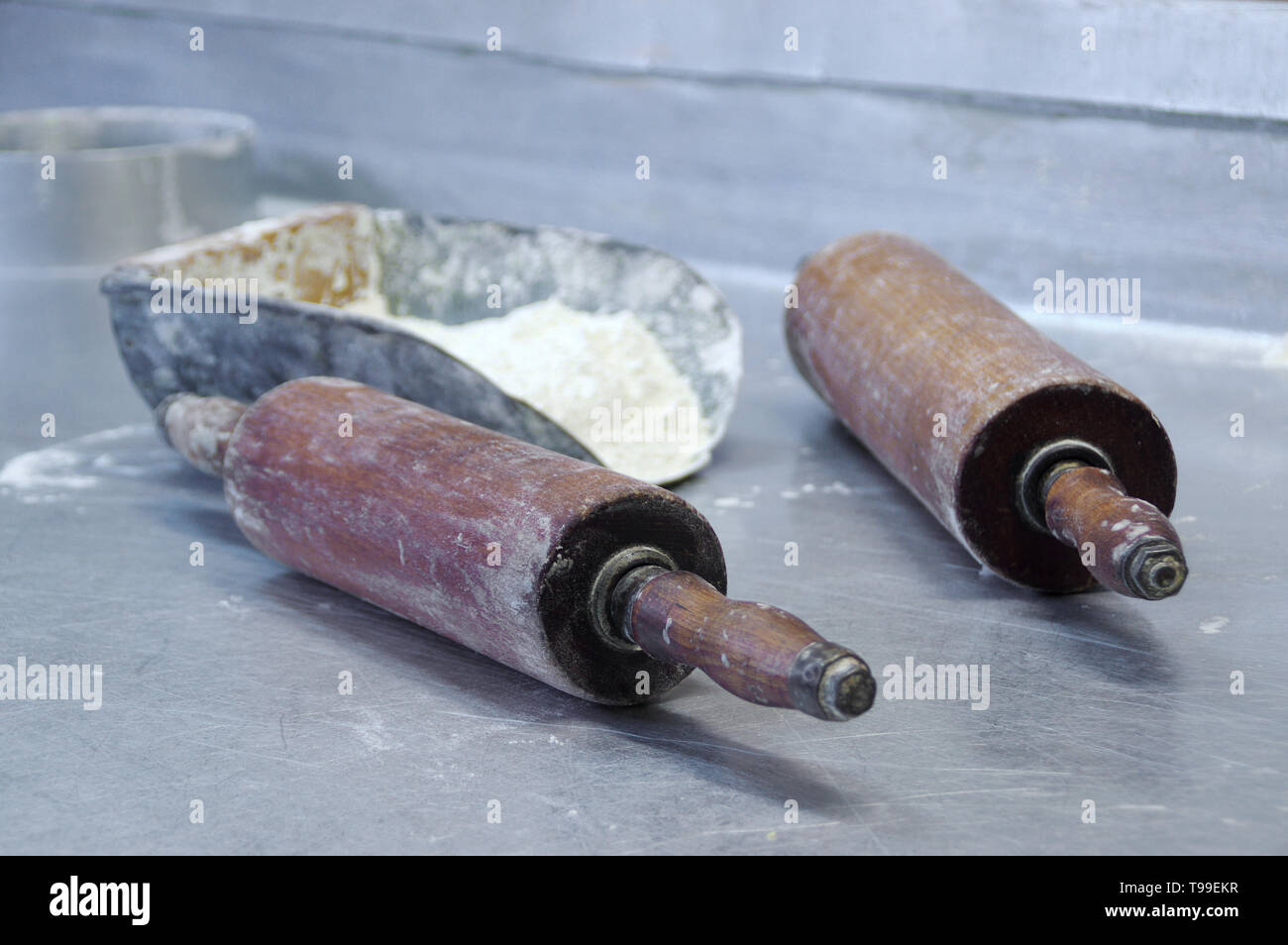 Flour and rollers on the table. Dough preparation in the bakery. Professional faktory. Stock Photo