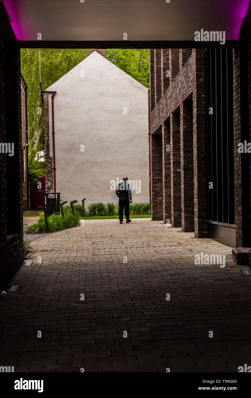Rear view of man walking away, Quayside, Newcastle upon Tyne, England, UK Stock Photo