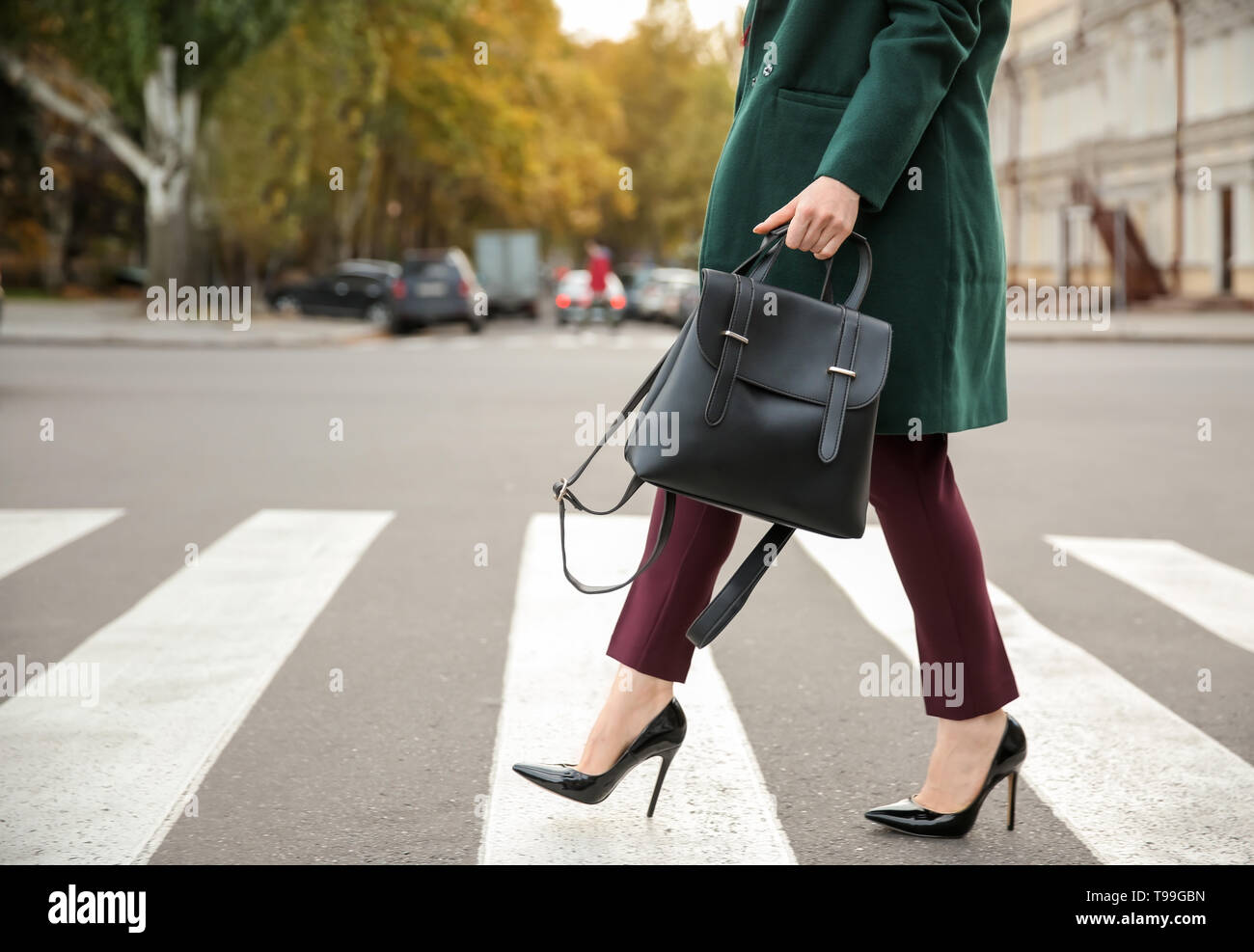 Beautiful fashionable woman crossing road Stock Photo - Alamy