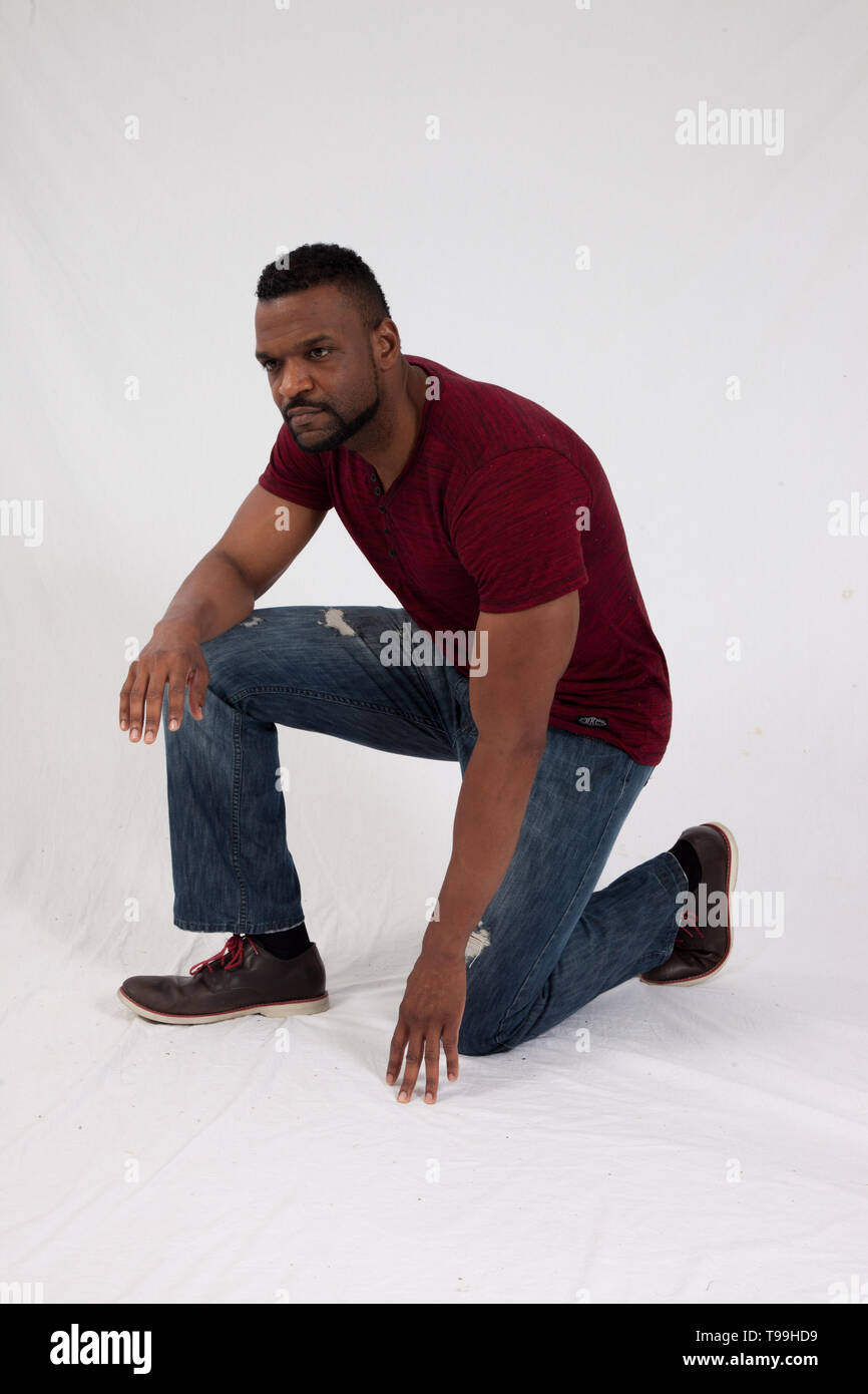 Man kneeling jeans hi-res stock photography and images - Alamy