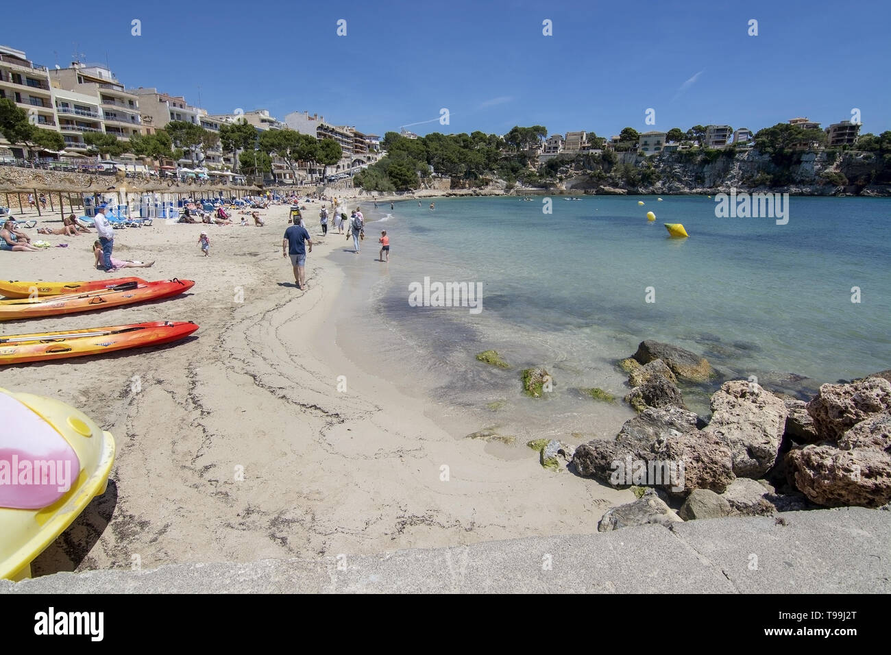 PORTO CRISTO, MALLORCA, SPAIN - MAY 16, 2019: Sandy beach with people on a sunny day on May 16, 2019 in Porto Cristo, Mallorca, Spain. Stock Photo