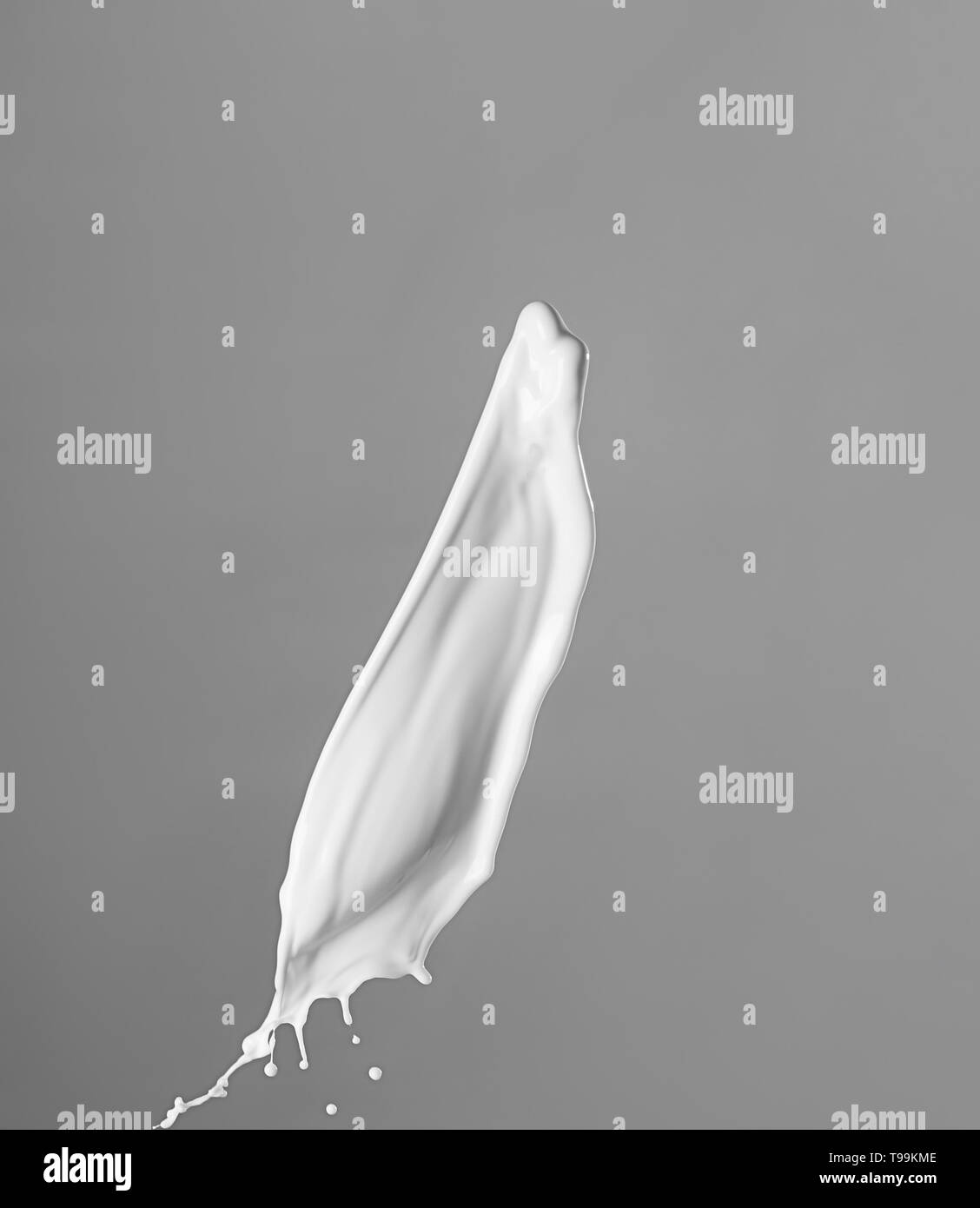 Splash of milk on grey background Stock Photo - Alamy