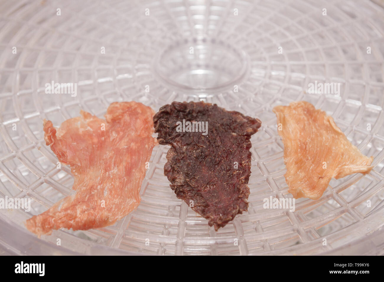 Dried Turkey meat chicken and beef on electric dryer Stock Photo Alamy