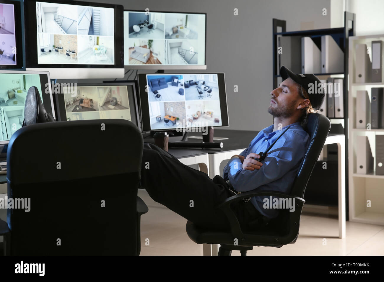 Security guard sleeping in surveillance room Stock Photo Alamy